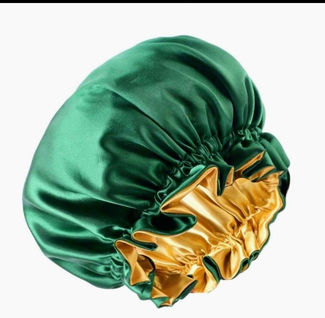 Green satin bonnet with gold interior on a white background