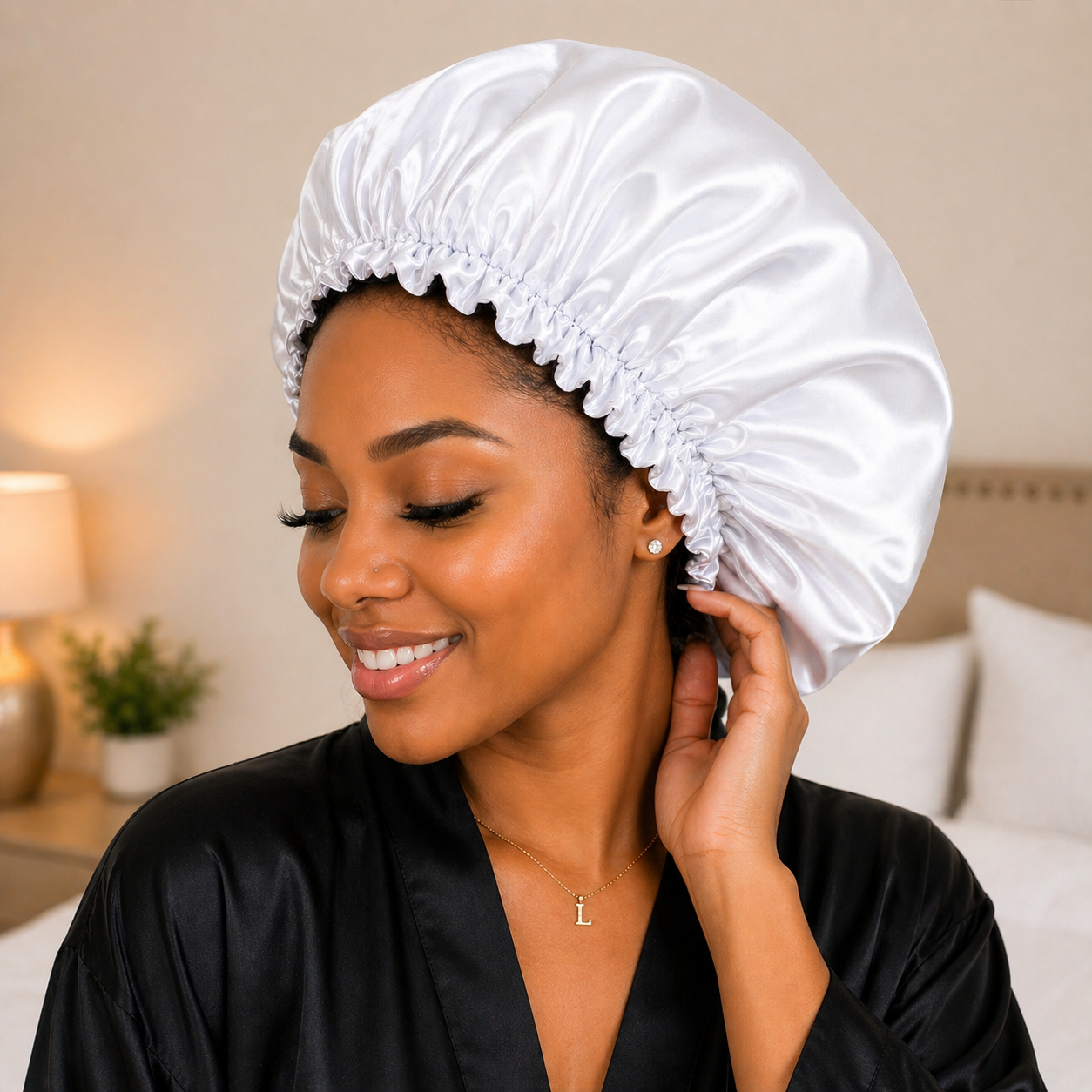 Woman wearing a white satin bonnet in a bedroom setting