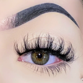 Close-up of an eye with long eyelashes and a well-groomed eyebrow.