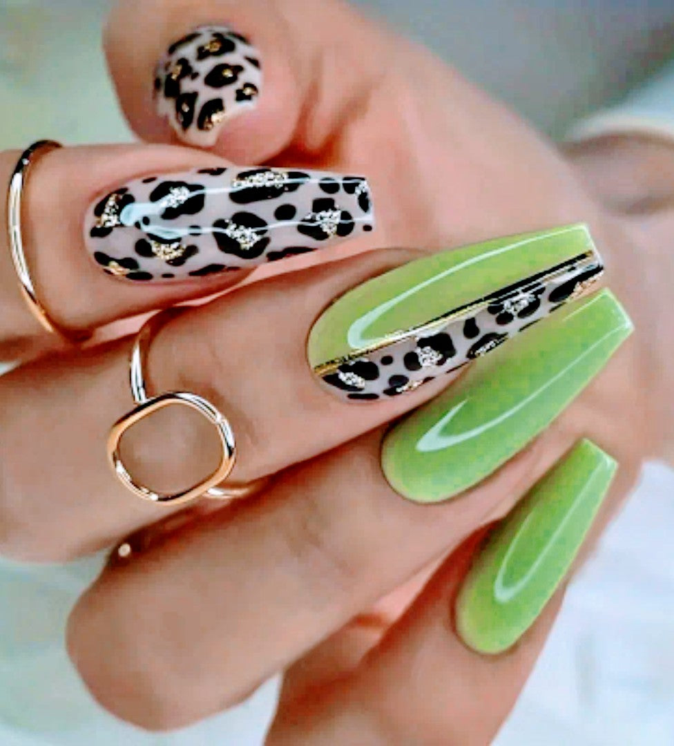 A set of long, coffin-shaped, green and black leopard print press-on nails with glue and a nail file included.