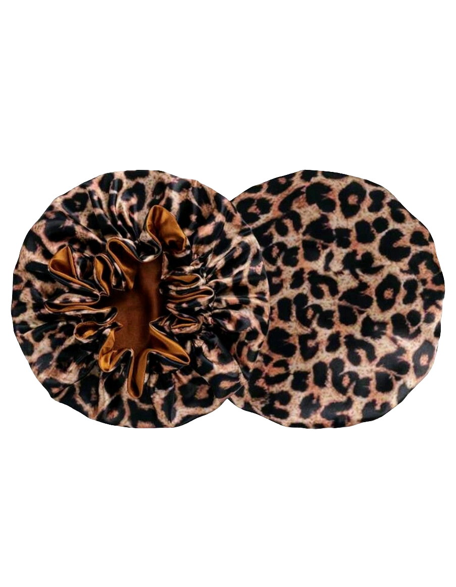 A reversible satin sleeping hair bonnet with leopard print on one side and solid brown on the other, displayed flat.