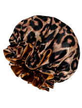 A leopard print reversible satin sleeping hair bonnet.