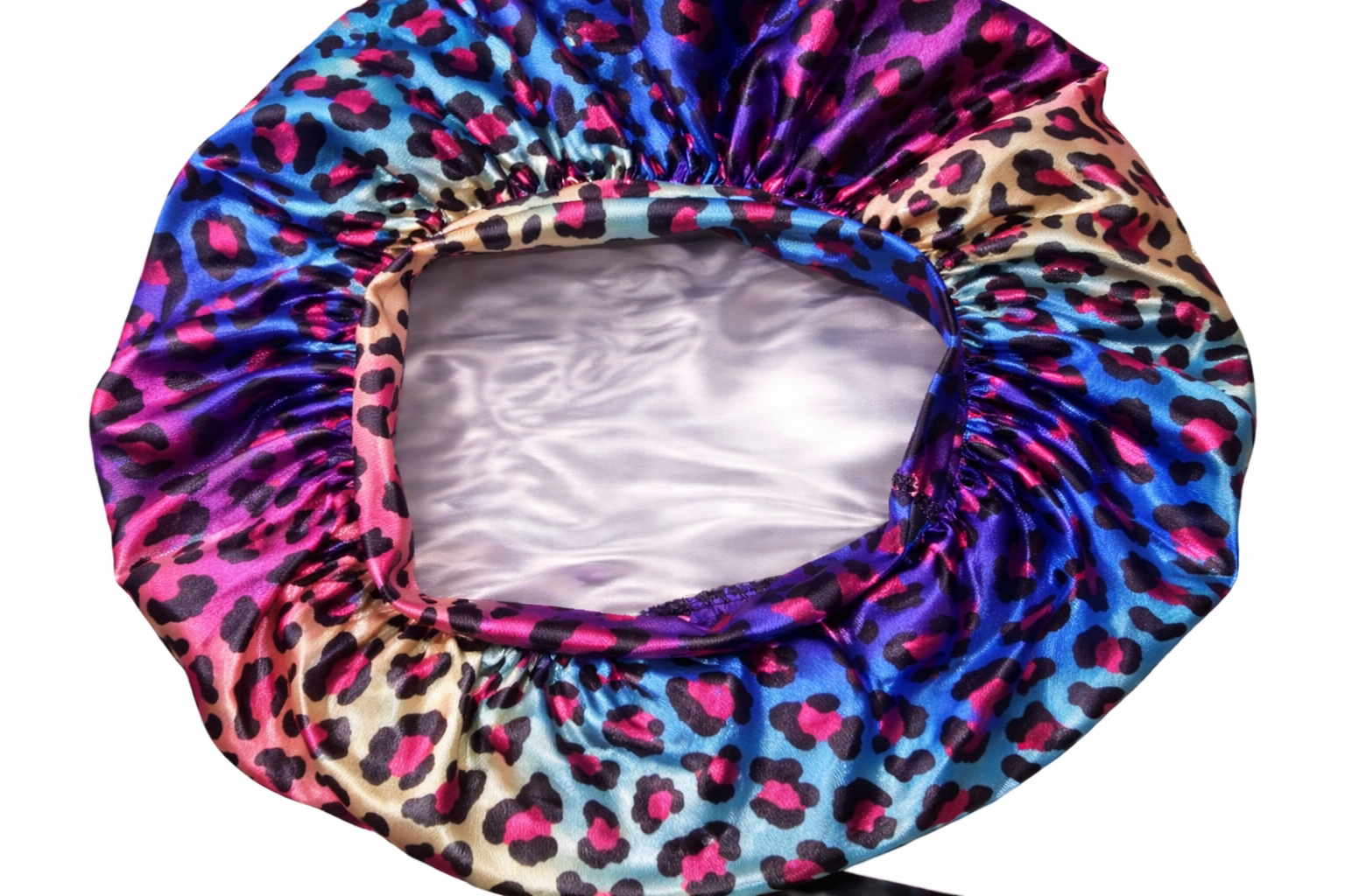 Colorful satin bonnet with leopard print pattern on a white background