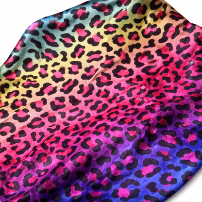 Colorful fabric with a leopard print pattern on a gradient background