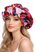 Woman wearing a colorful patterned shower cap on a white background
