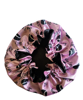 Pink satin hair bonnet with black bonnet design and &