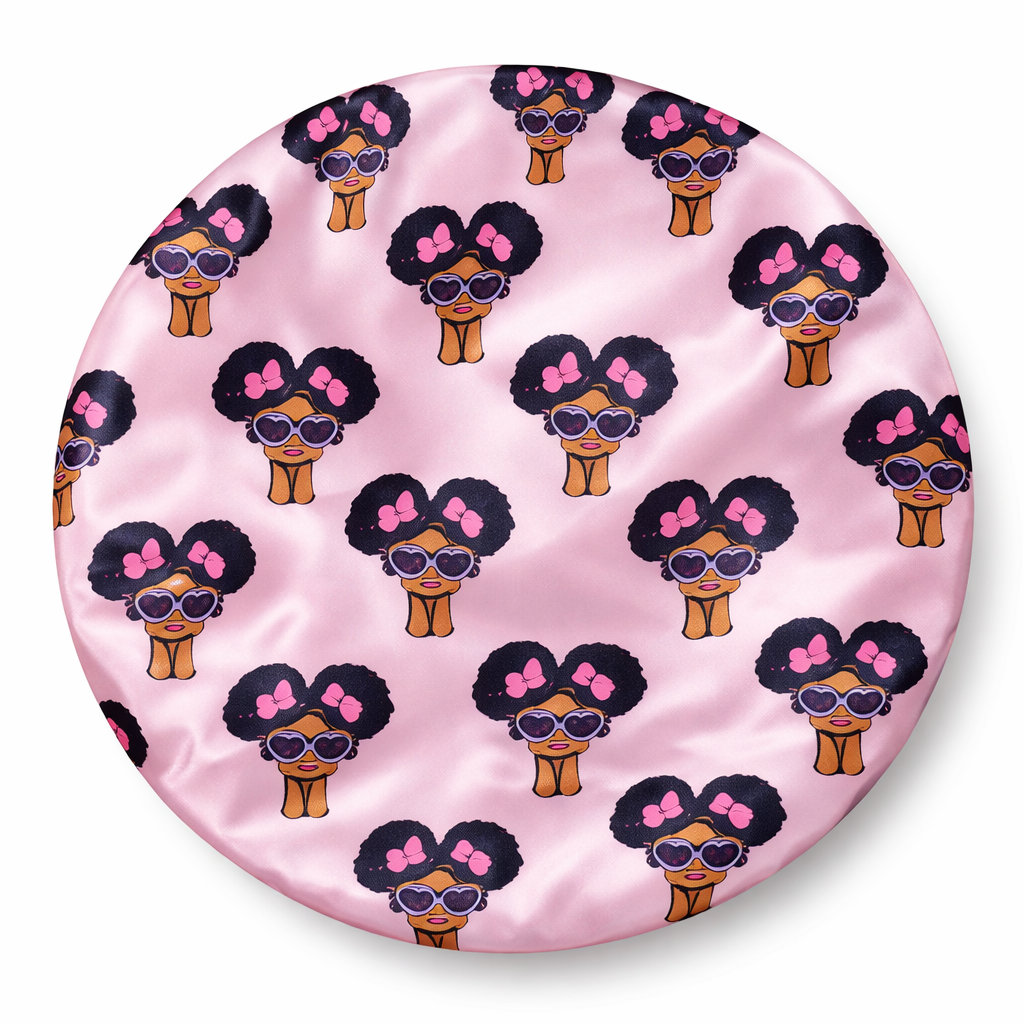 Pink satin pillow with cartoon characters pattern on a white background
