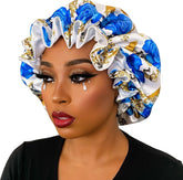 Woman wearing a decorative blue, white, and gold headscarf on a beige background