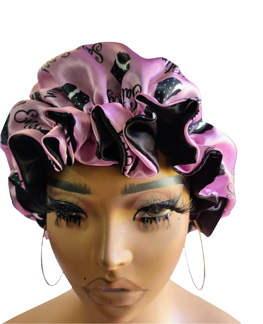 Pink and black decorative bonnet on a mannequin head with a white background