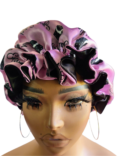 Pink and black decorative bonnet on a mannequin head with a white background