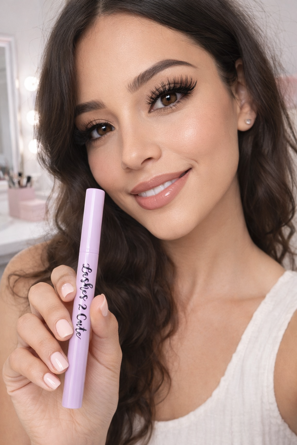 Woman holding a purple makeup product with a blurred background