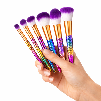 Set of colorful makeup brushes held by a hand on a white background