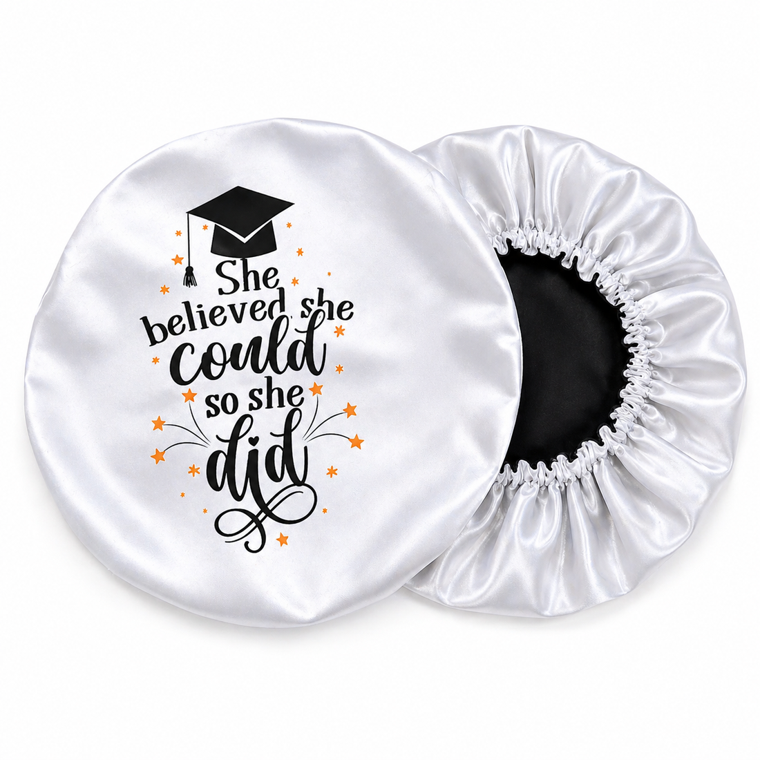 White satin hair bonnet with graduation-themed text and design on a white background