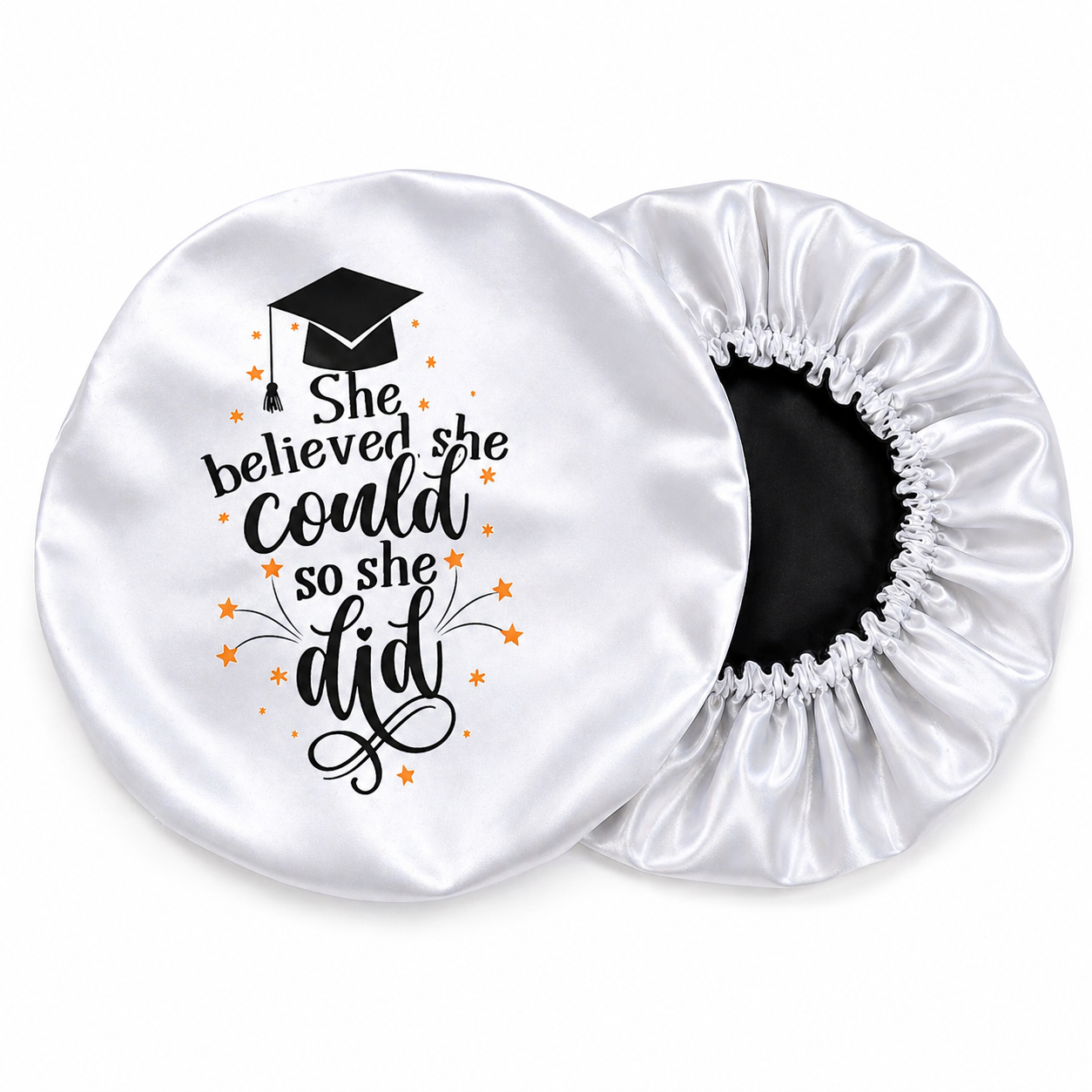 White satin hair bonnet with graduation-themed text and design on a white background
