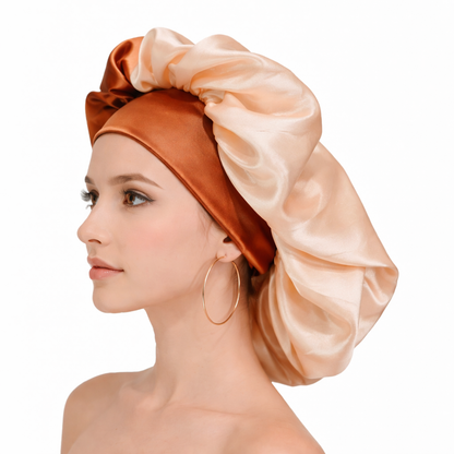 Woman wearing a satin hair wrap in peach and orange on a white background