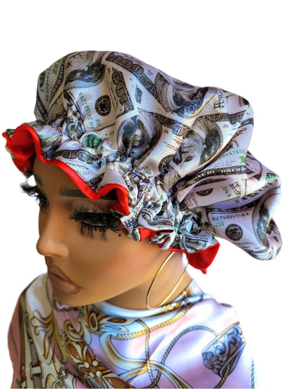 A woman wearing a reversible sleeping satin hair bonnet with a wavy pattern and dollar bill design.